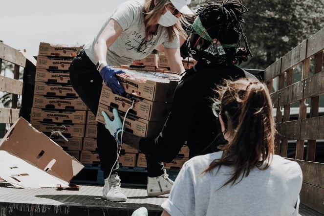 People unloading items off of a truck.